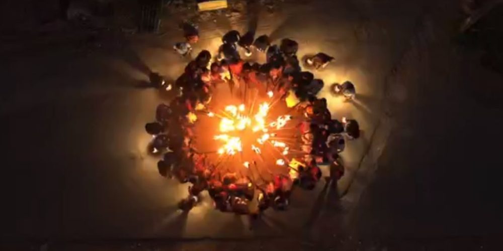 5. People circle for fire, birds eye view